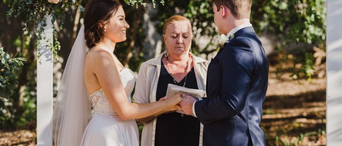 A couple laughing with their marriage celebrant at the alter in Townsville Queensland
