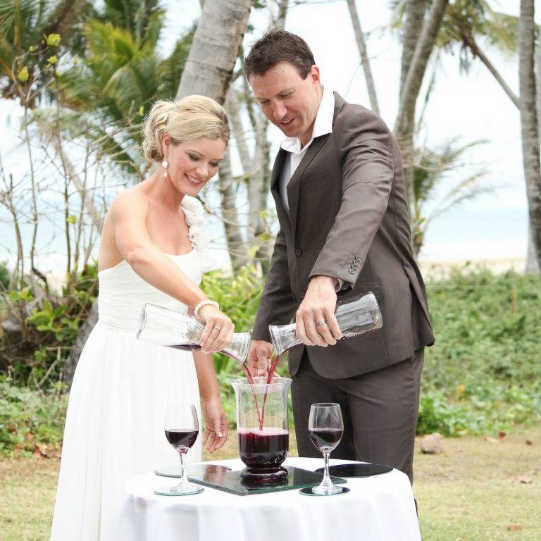 A Newly Wed couple perform a Wine Unity Ceremony at wedding ceremony performed by Jenny Stevens Magnetic Island